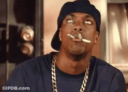 Man Smoking Cigarette With Hat And Chains GIF