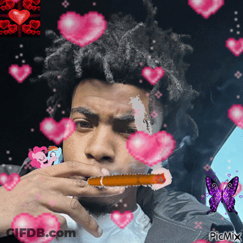 Man Smoking Cigarette With Hearts Around Him GIF