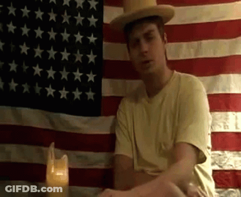 Man Smoking In Front Of American Flag GIF