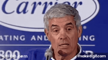 Man Speaking Into Microphone In Front Of Carrier Logo GIF
