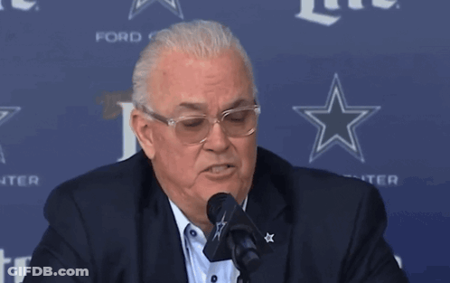 Man Speaking Into Microphone In Front Of Ford Sign GIF