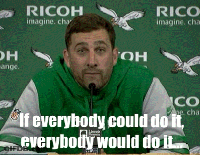 Man Speaking Into Microphone In Front Of Ricoh Sign GIF