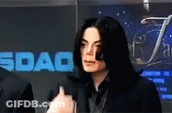 Man Speaking Into Microphone In Front Of Sdaq Sign GIF