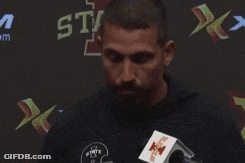 Man Speaking Into Microphone In Front Of State Sign GIF