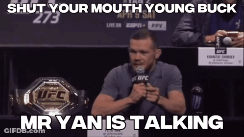 Man Speaking Into Microphone In Front Of UFC Championship Belt GIF