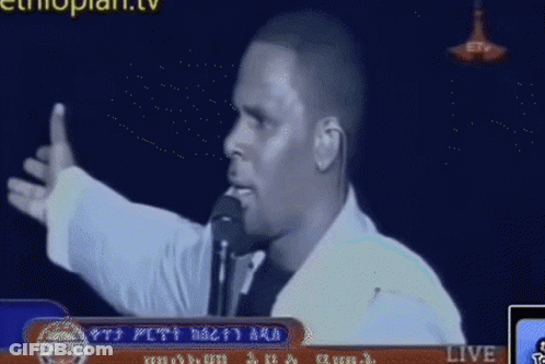 Man Speaking Into Microphone On TV GIF