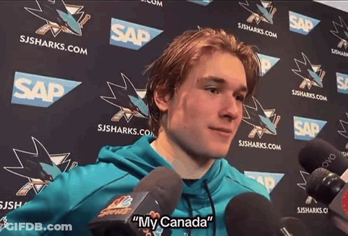 Man Speaking Into Microphone With My Canada Behind Him GIF
