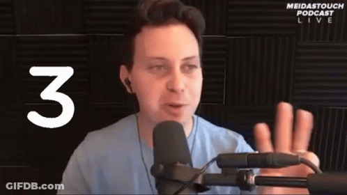Man Speaking Into Microphone With Number 3 GIF