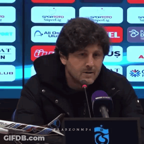 Man Speaking Into Microphone With Spor Toto Superlig Screen GIF