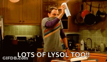 Man Spraying Lysol On Kitchen Counter GIF