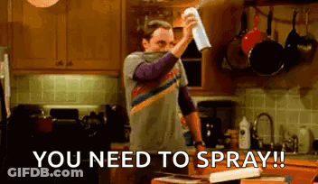 Man Spraying Something In Kitchen With Towel GIF