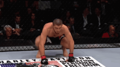 Man Squatting At Harley Davidson Sign GIF