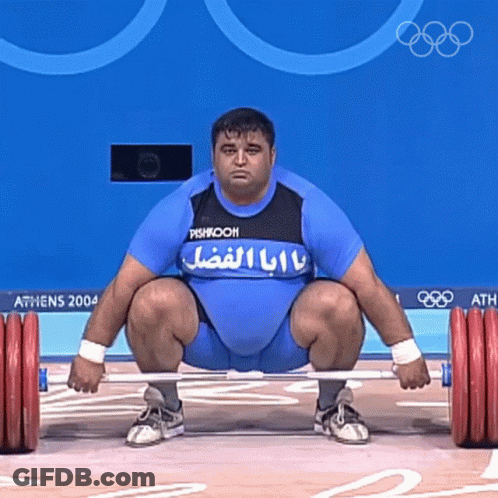 Man Squatting Holding Barbell Athens 2004 GIF