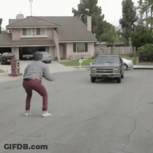 Man Squatting In Front Of Chevrolet Truck GIF