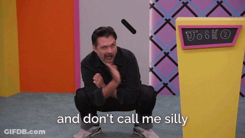 Man Squatting In Front Of Josh Don't Call Me Silly Sign GIF
