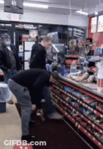 Man Squatting In Store With Exit Sign GIF