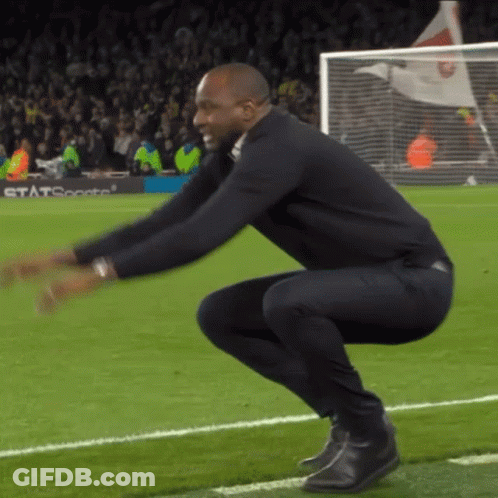 Man Squatting On Soccer Field GIF