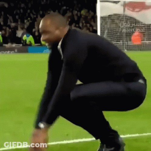 Man Squatting On Soccer Field GIF