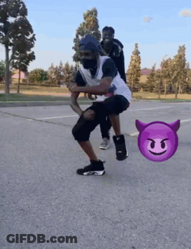 Man Squatting With Devil Emoji Behind GIF
