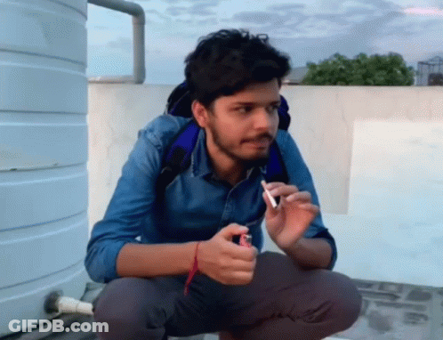 Man Squatting With Lighter And Cigarette GIF