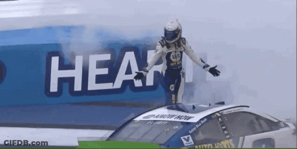 Man Standing As Winner Above Race Car GIF