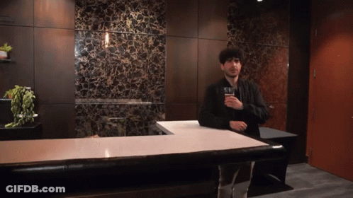 Man Standing At Counter With Beer GIF
