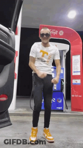 Man Standing At Gas Pump GIF
