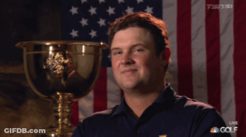 Man Standing Before American Flag And Trophy GIF