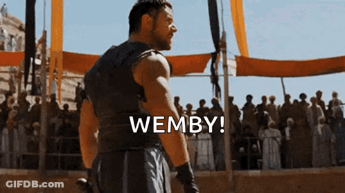 Man Standing Before Crowd Saying Wemby GIF