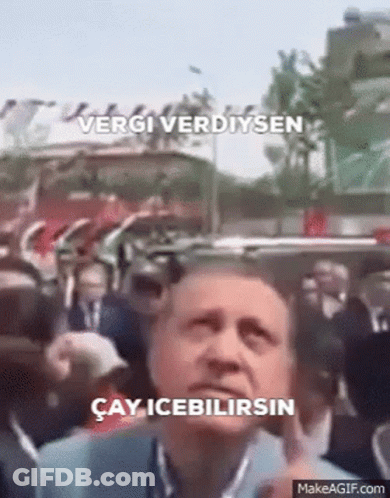 Man Standing Before Crowd With Vergi Verdiysen Sign GIF