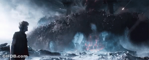 Man Standing Before Desert Rock Formation GIF