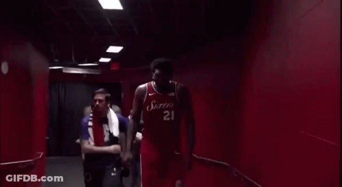 Man Standing Before Exit Sign GIF