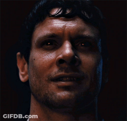 Man Standing Before Skull Crowd GIF