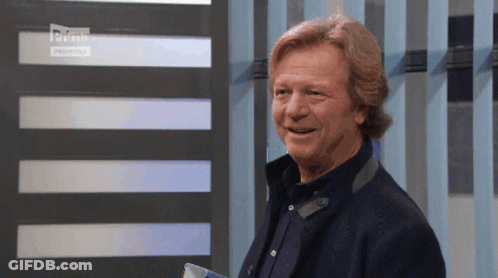Man Standing Before Striped Wall Saying Prime GIF