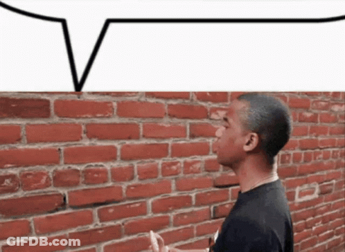 Man Standing By Brick Wall With Speech Bubble GIF