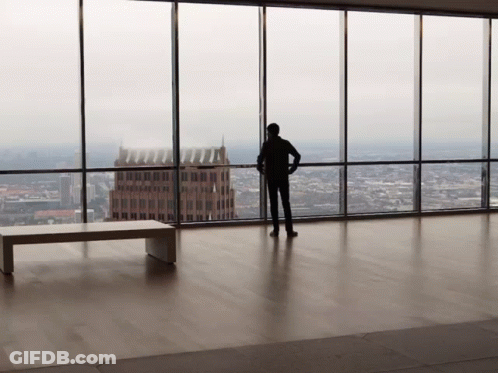 Man Standing By City View Window GIF