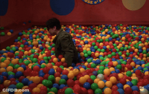 Man Standing In Ball Pit With Bazinga GIF