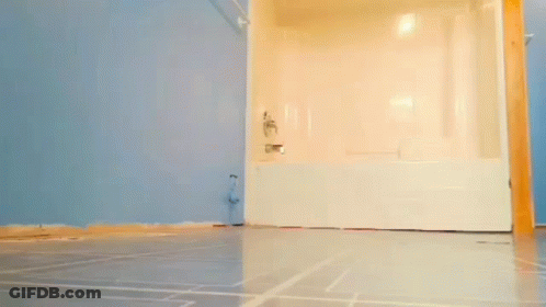 Man Standing In Bathroom Next To Bathtub GIF