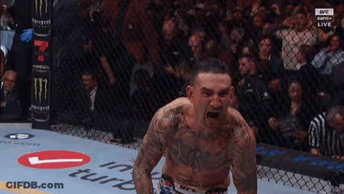 Man Standing In Boxing Ring With Arms Out GIF