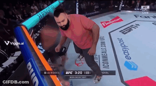 Man Standing In Boxing Ring With Budweiser Ads GIF
