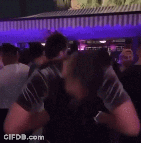 Man Standing In Crowd At Party GIF