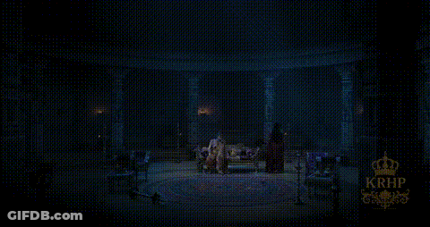 Man Standing In Dark Room With Crown GIF