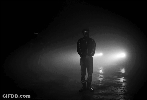 Man Standing In Darkness Behind Car GIF