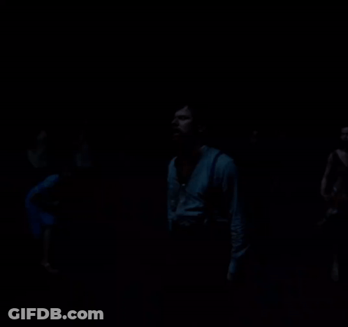 Man Standing In Darkness Looking Up GIF