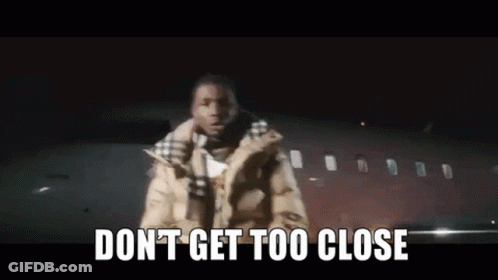 Man Standing In Front Of Airplane Saying Don't Get Too Close GIF