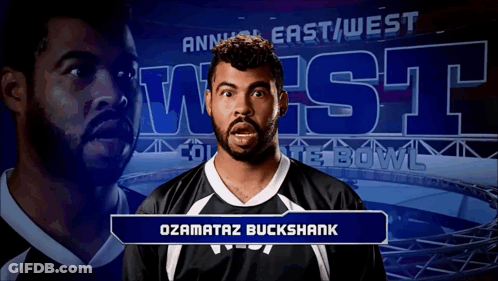 Man Standing In Front Of Annual East West Bowl Sign GIF