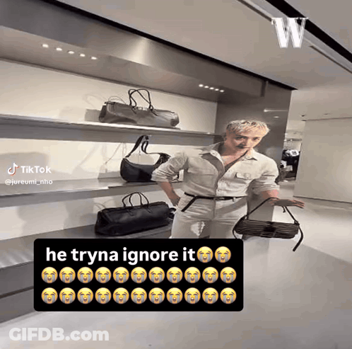 Man Standing In Front Of Bags Saying He Tryna Ignore It GIF