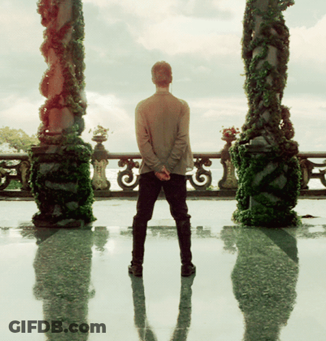 Man Standing In Front Of Balcony GIF