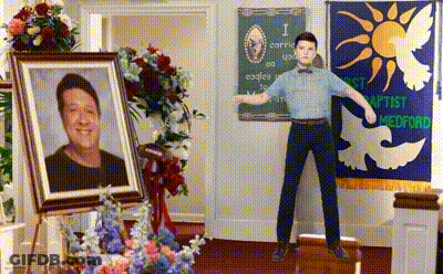 Man Standing In Front Of Baptist Medford Banner GIF