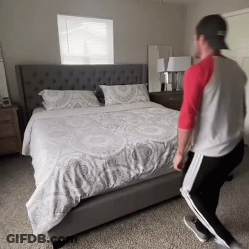 Man Standing In Front Of Bed GIF